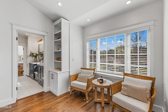 living area with light wood-type flooring and recessed lighting