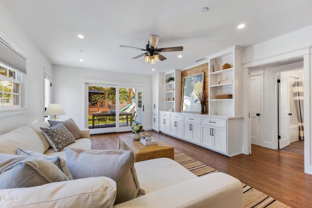 living area with recessed lighting, a healthy amount of sunlight, and wood finished floors