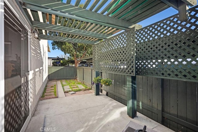 view of patio / terrace featuring fence and a pergola