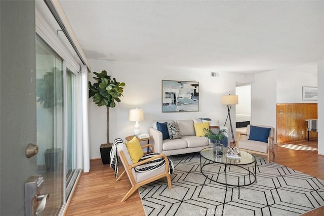 living area with visible vents and light wood finished floors