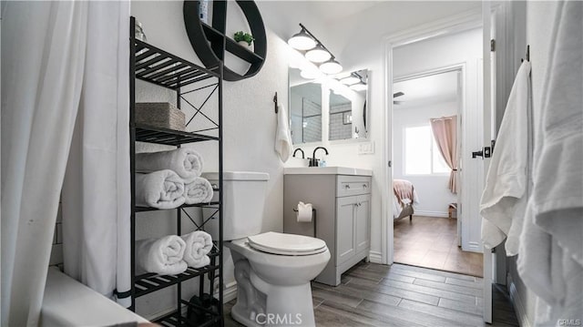 670 Ducor Ave, Landers, CA 92285 - bathroom with wood finished floors, vanity, toilet, and baseboards