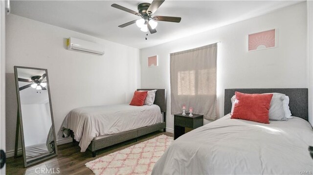 670 Ducor Ave, Landers, CA 92285 - bedroom with a wall mounted AC, wood finished floors, and a ceiling fan