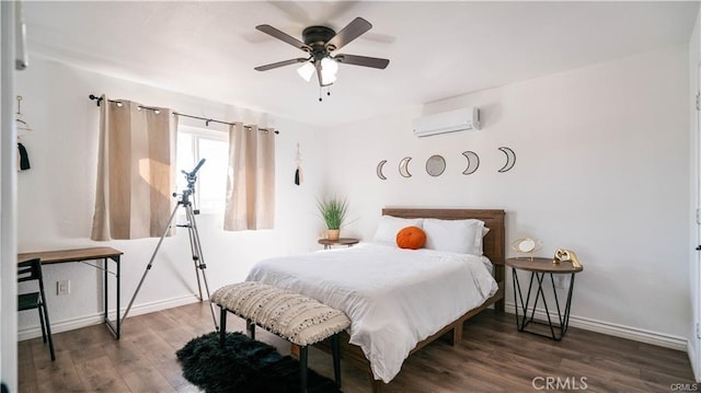 bedroom featuring ceiling fan, baseboards, an AC wall unit, and wood finished floors