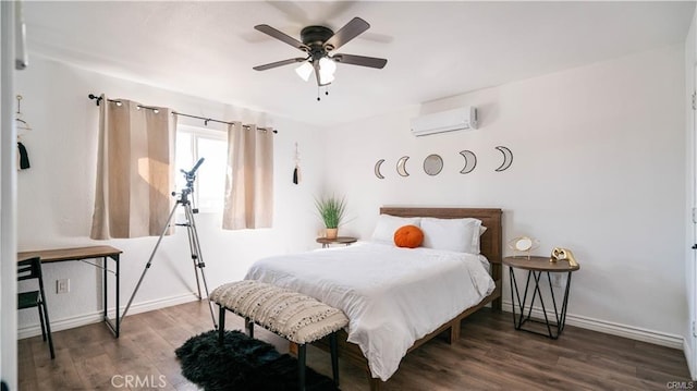 670 Ducor Ave, Landers, CA 92285 - bedroom featuring an AC wall unit, baseboards, wood finished floors, and a ceiling fan