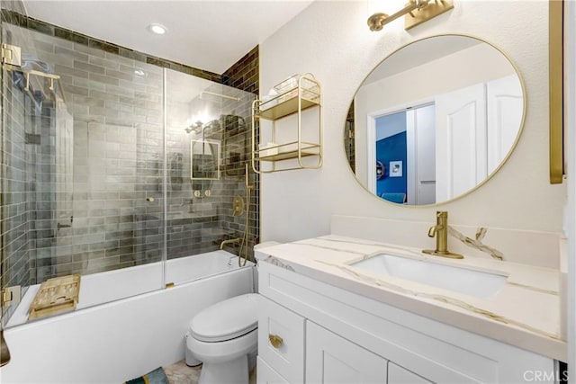 bathroom with toilet, recessed lighting, combined bath / shower with glass door, and vanity