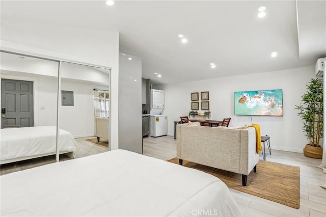 bedroom featuring recessed lighting, electric panel, lofted ceiling, and light wood finished floors