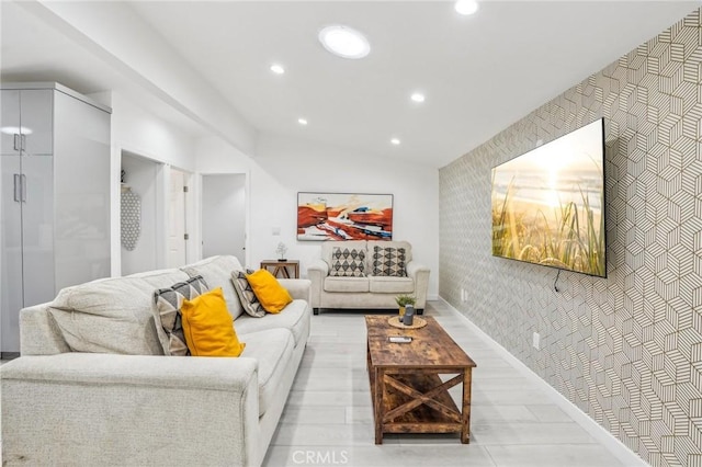 living area featuring an accent wall, recessed lighting, vaulted ceiling, and wallpapered walls