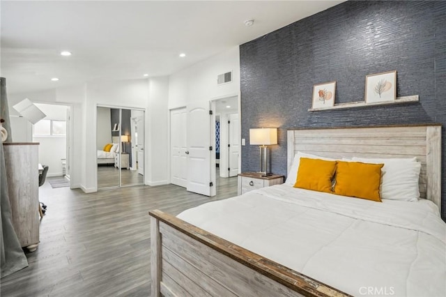 bedroom with recessed lighting, wood finished floors, visible vents, baseboards, and vaulted ceiling