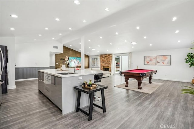 playroom with vaulted ceiling with beams, billiards, a sink, visible vents, and light wood-style floors