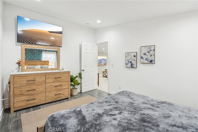 bedroom with dark wood-style floors and recessed lighting