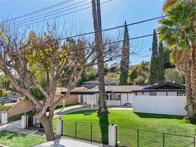 view of front facade featuring a fenced front yard and a front lawn