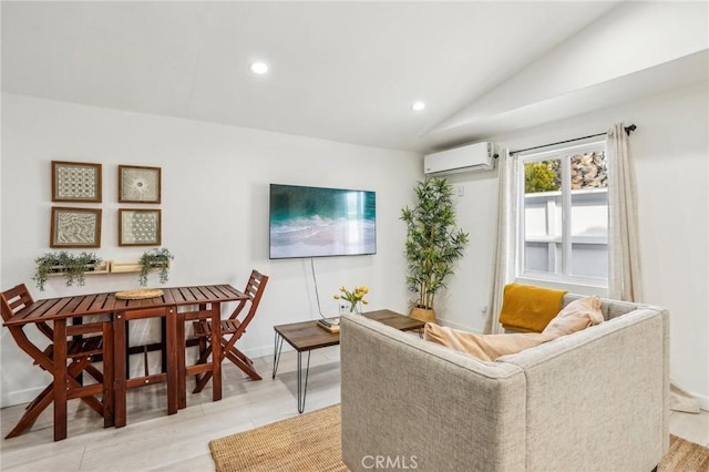 living room with baseboards, a wall mounted air conditioner, vaulted ceiling, light wood-style floors, and recessed lighting