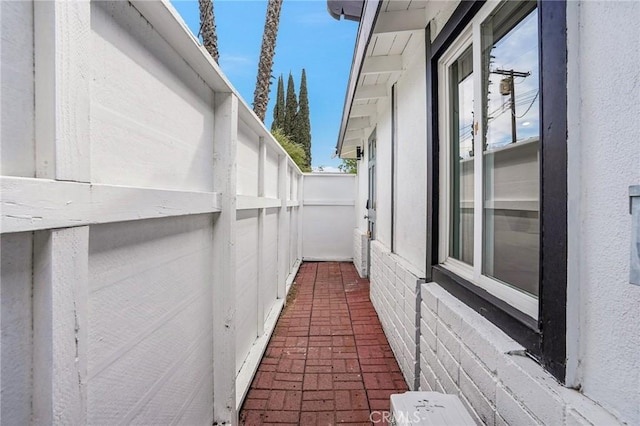 view of side of home featuring fence