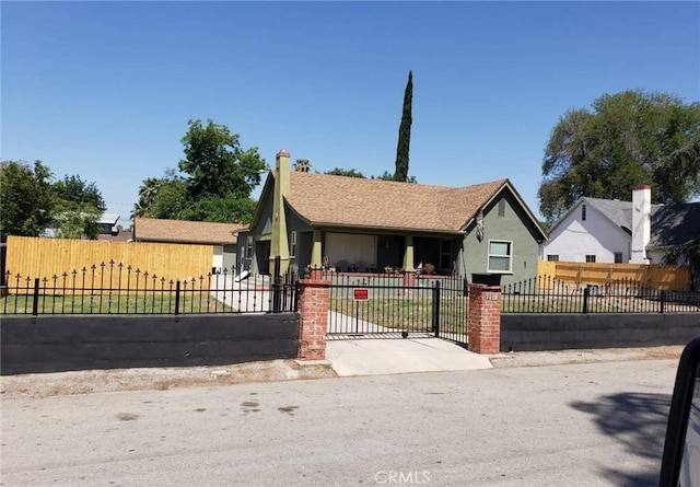 view of front of home featuring a fenced front yard and a gate