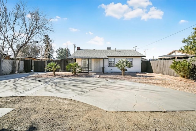 ranch-style home with fence