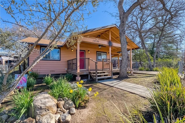 view of front of home featuring fence and ceiling fan