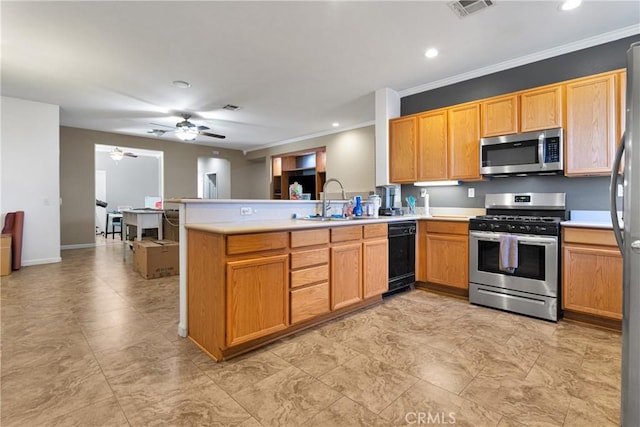 kitchen with appliances with stainless steel finishes, light countertops, and a peninsula