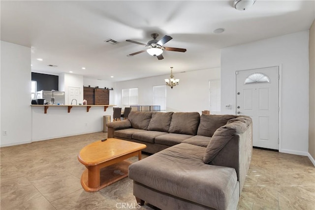 living room featuring recessed lighting, baseboards, visible vents, and ceiling fan with notable chandelier