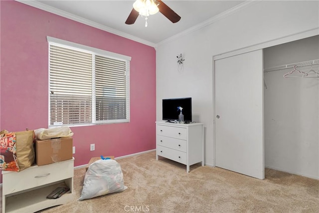 bedroom with a closet, light carpet, crown molding, and ceiling fan