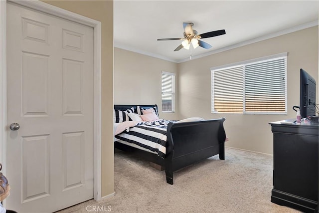 bedroom featuring light carpet, baseboards, a ceiling fan, and crown molding