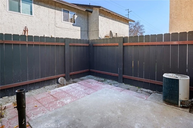 view of patio with central AC and a fenced backyard