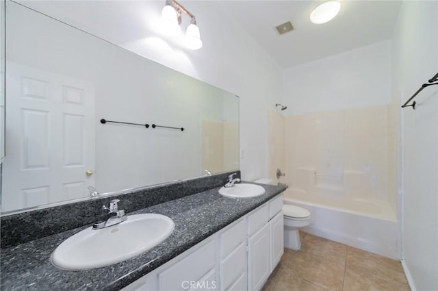 full bath with a sink, bathing tub / shower combination, toilet, and tile patterned floors