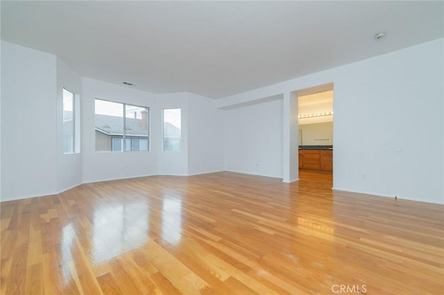 unfurnished room featuring visible vents and light wood-style flooring