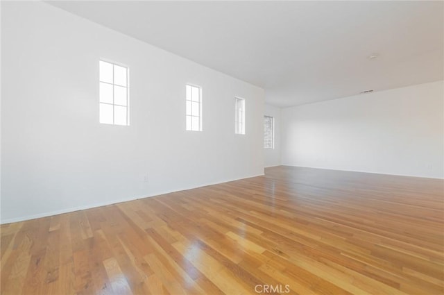 unfurnished room with light wood-type flooring