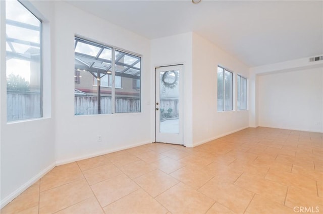 unfurnished room featuring visible vents, baseboards, and light tile patterned floors