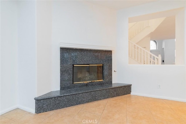 details with a high end fireplace and baseboards