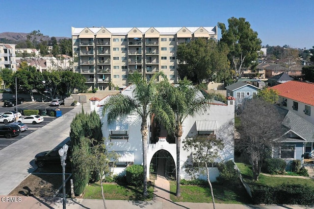 view of building exterior featuring uncovered parking