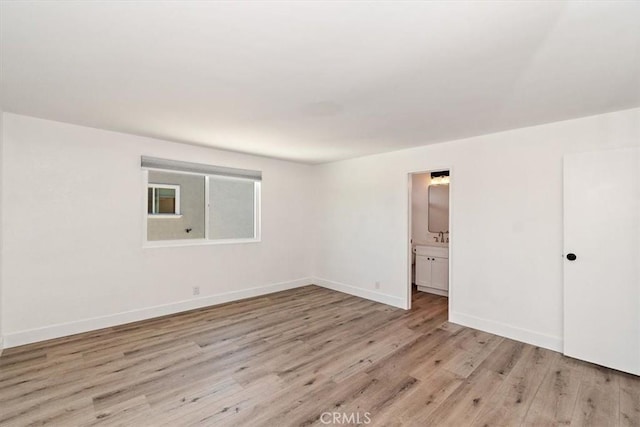 interior space featuring light wood-style flooring and baseboards