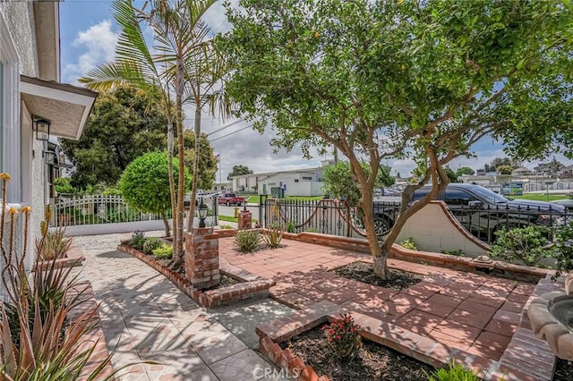 view of patio / terrace with a residential view and fence