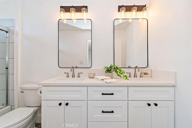 full bath featuring a sink, toilet, and double vanity