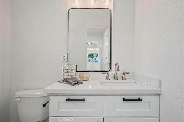 bathroom with toilet and vanity