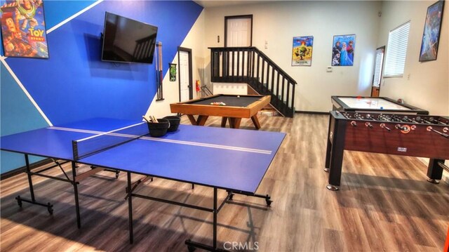 recreation room with billiards, baseboards, and wood finished floors