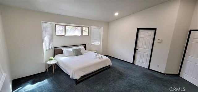 bedroom with recessed lighting, baseboards, lofted ceiling, and dark carpet