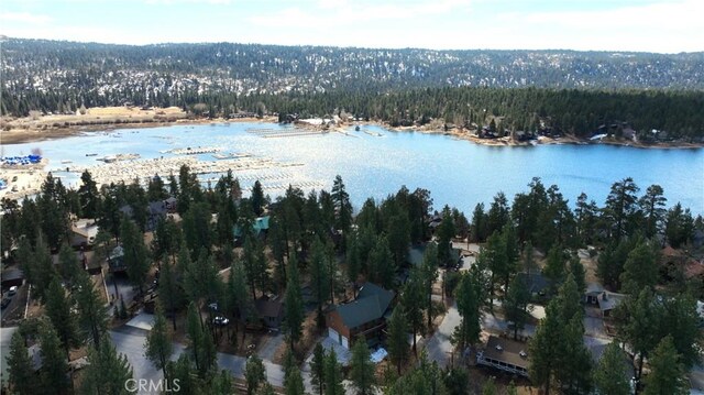 aerial view with a wooded view and a water view