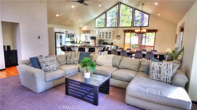 living area featuring a notable chandelier, recessed lighting, high vaulted ceiling, and light wood-style floors