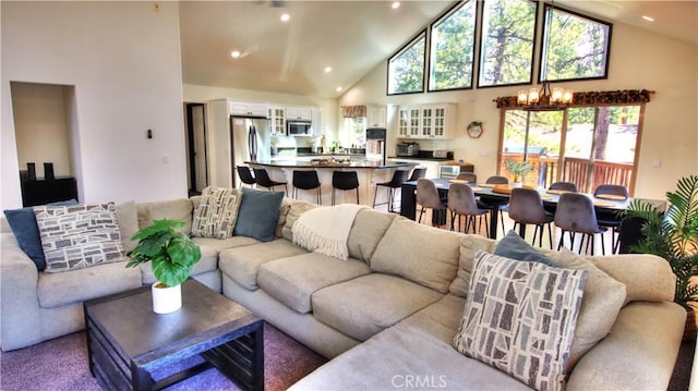 living room with recessed lighting, a notable chandelier, and high vaulted ceiling