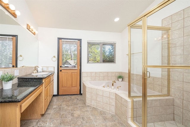 bathroom with a bath, tiled shower, vanity, and recessed lighting