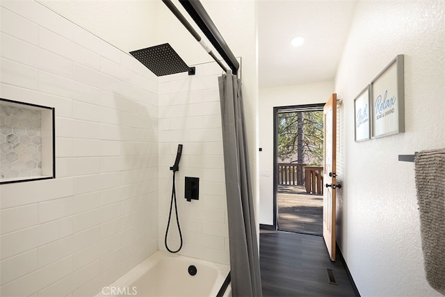 bathroom featuring shower / bath combo and wood finished floors
