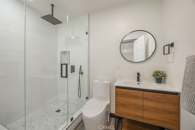 bathroom featuring a stall shower, toilet, and vanity