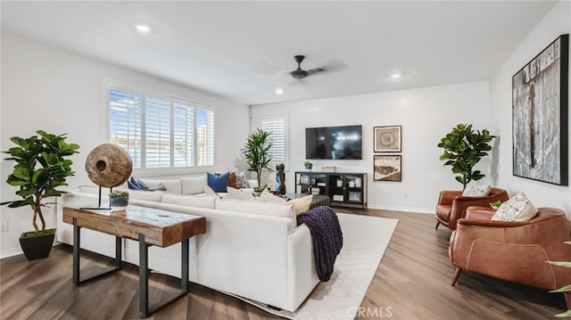 living area with a ceiling fan, recessed lighting, baseboards, and wood finished floors