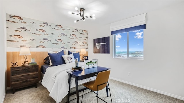 bedroom with baseboards, carpet floors, and a notable chandelier