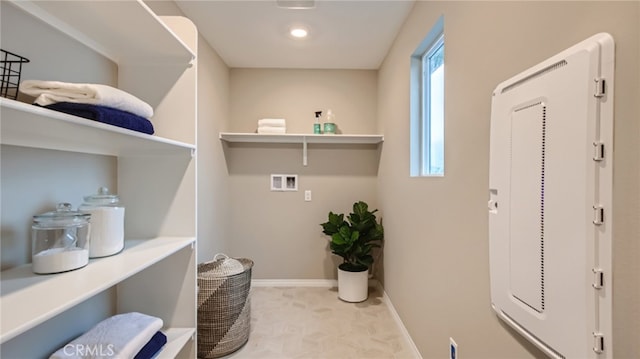 laundry area featuring laundry area, carpet, hookup for a washing machine, and baseboards