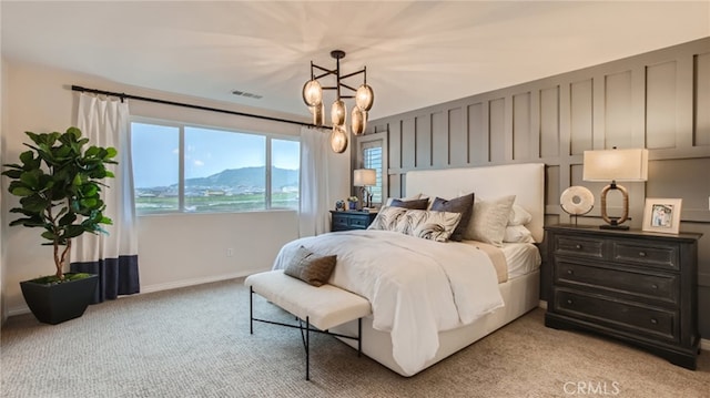 bedroom featuring light carpet, baseboards, visible vents, and a notable chandelier