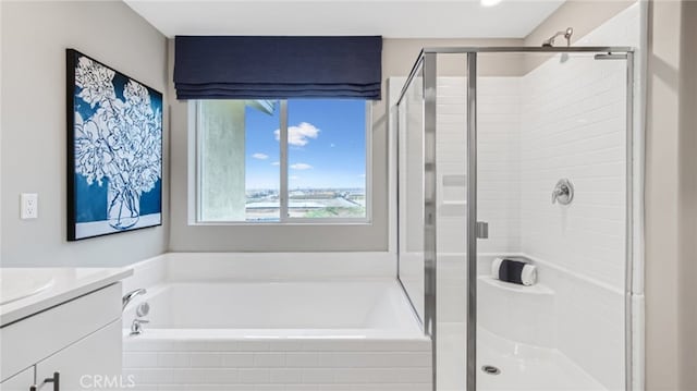 bathroom with a garden tub, a shower stall, and vanity