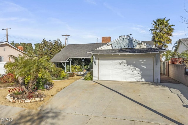 view of front of property featuring a shingled roof, fence, and stucco siding