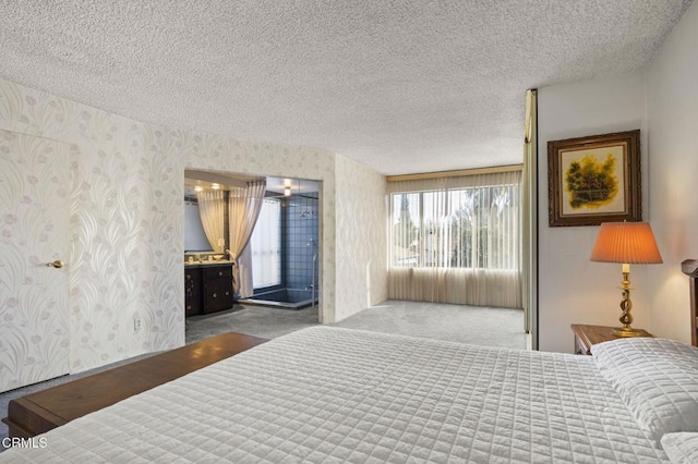 bedroom with wallpapered walls, carpet, and a textured ceiling